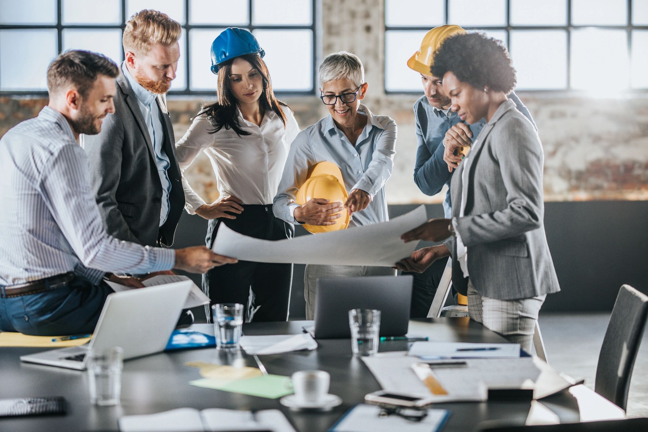 Engineering team reviewing plans together, representing collaborative project support