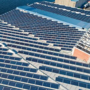 Large solar panel installation on industrial building roof