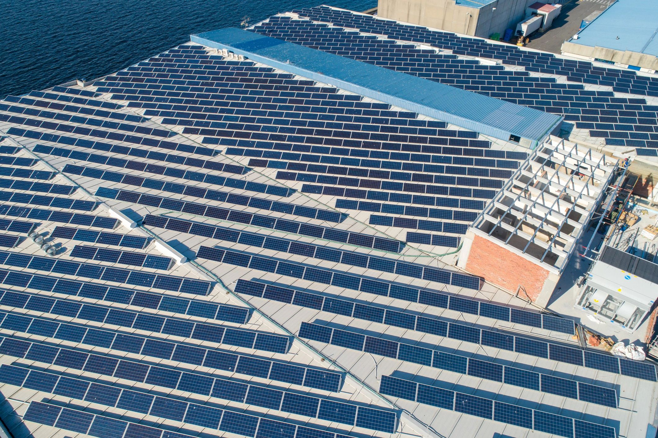 Rooftop solar panels on an industrial facility generating clean energy